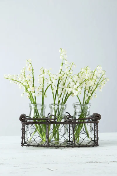 Lily of the Valley in bottles — Stock Photo, Image