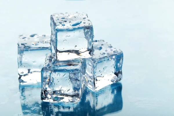 Ice cubes on blue — Stock Photo, Image