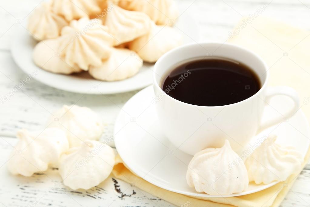 French meringue cookies with cup of coffee