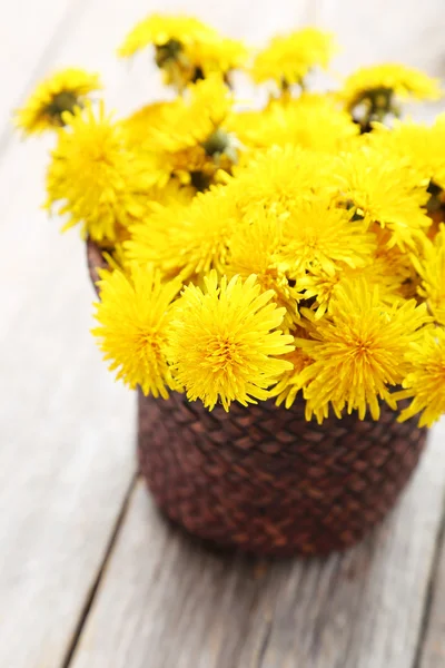 Yellow dandelions in basket — Stock Photo, Image