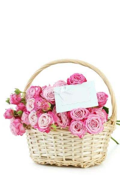 Beautiful pink roses in basket with empty card — Stock Photo, Image