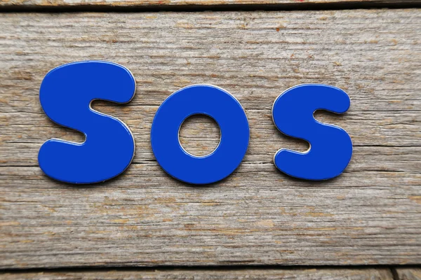 Sos word made of colorful magnets — Stock Photo, Image