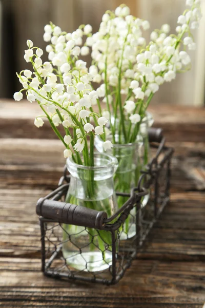 Lily of the Valley in bottles — Stock Photo, Image