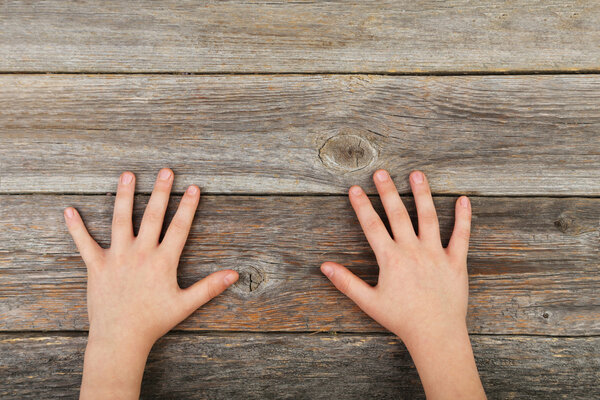 Child hands on grey