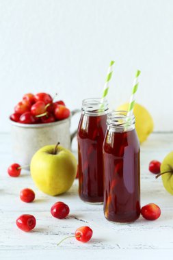 Glass of cherry juice with apples