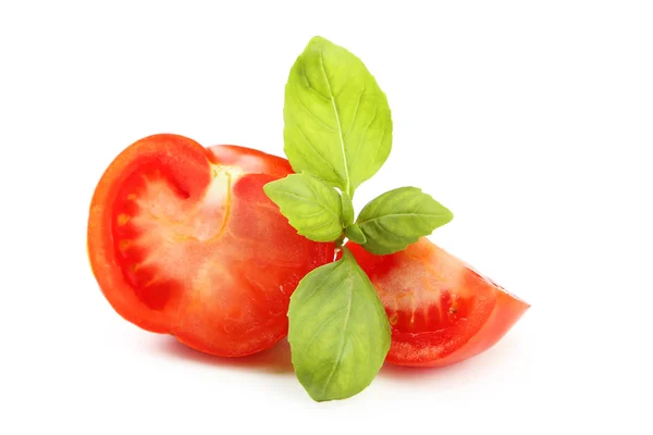 Tomatoes and basil leaves — Stock Photo, Image