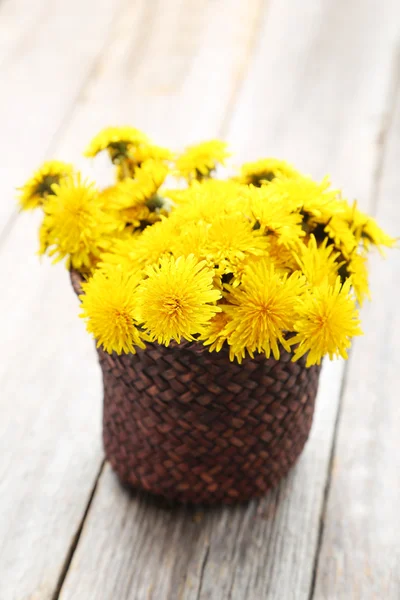 Yellow dandelions in basket — Stock Photo, Image