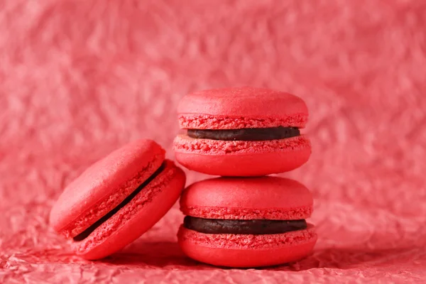 Red macarons on red paper background — Stock Photo, Image