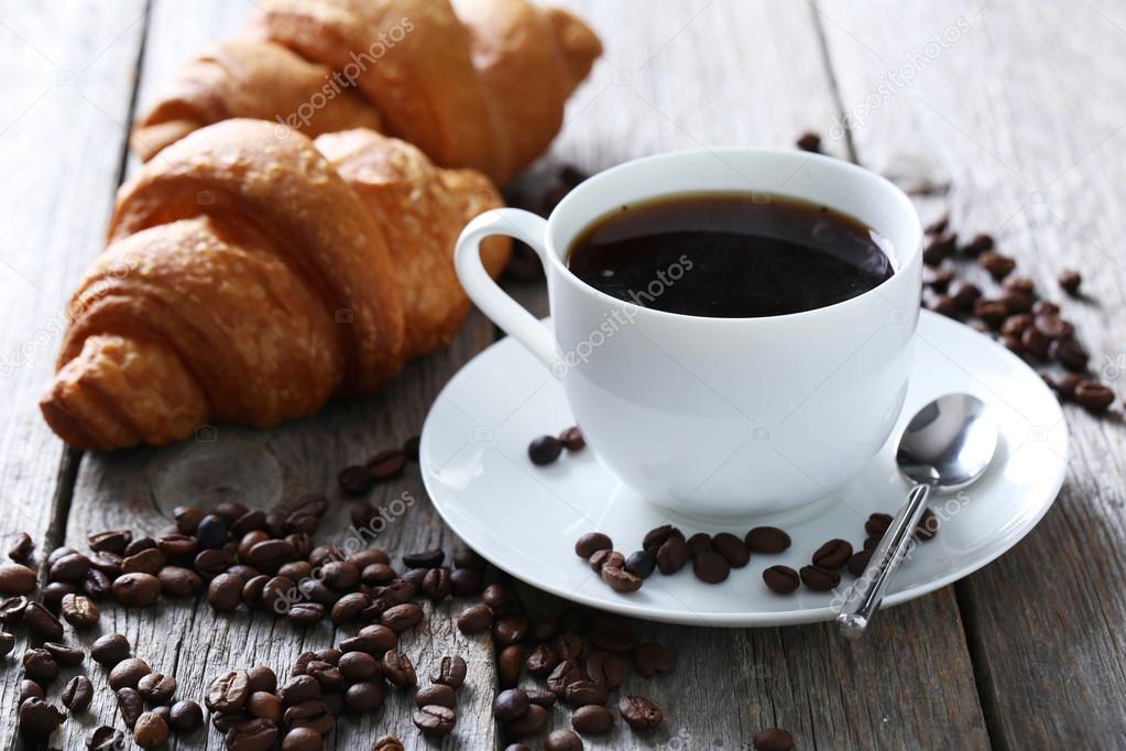 Delicious croissants with cup of coffee