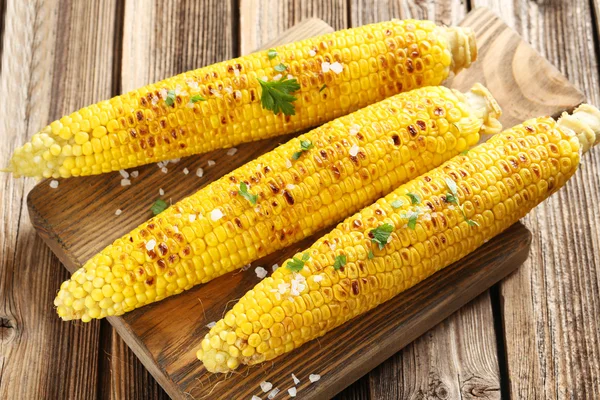 Fresh tasty grilled corns with butter — Stock Photo, Image