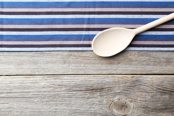 Wooden spoon and napkin on grey background — 스톡 사진