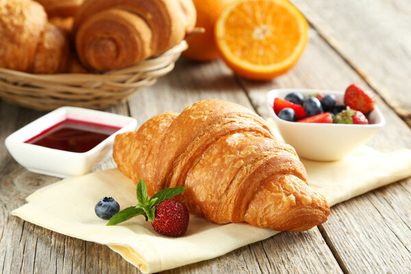 Fresh tasty croissants with berries