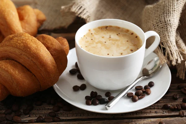 Delicious croissants with cup of coffee — Stock Photo, Image