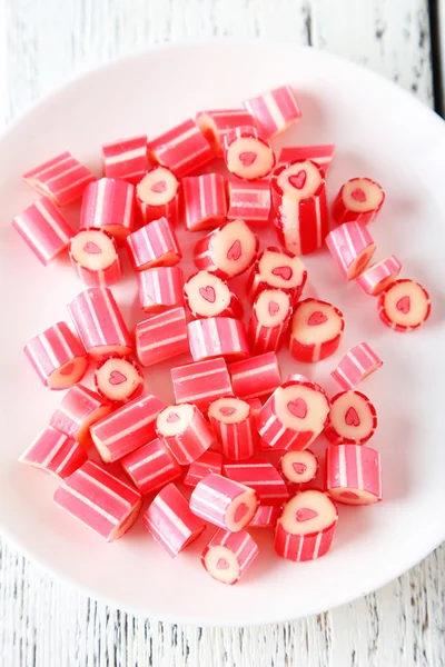 Candies on wooden background — Stock Photo, Image