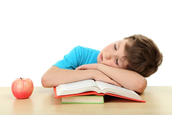 Prachtige kleine jongen slaap op boeken geïsoleerd op wit — Stockfoto