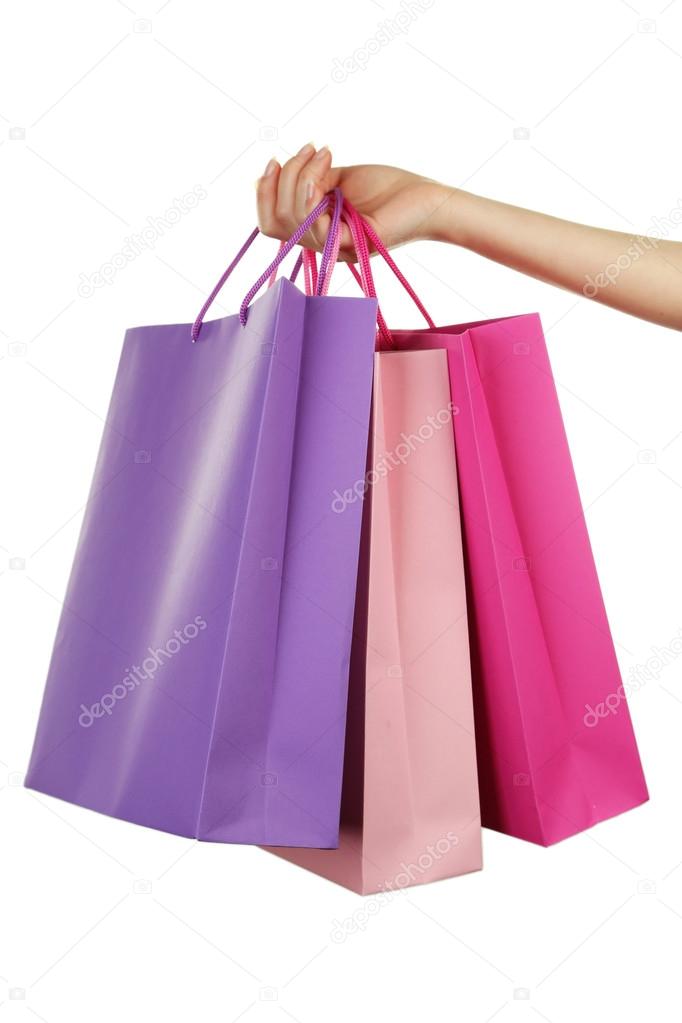 hand holding colorful shopping bags