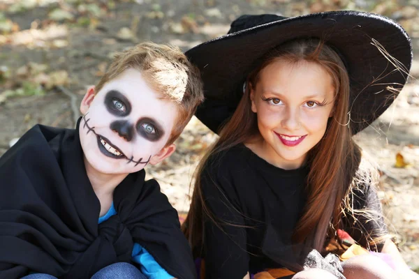 Beautiful girl witch and little boy in the park, outdoors — Stock Photo, Image