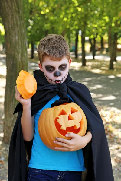 Little boy in halloween costume with pumpkin in the park, outdoo — Stock Photo, Image