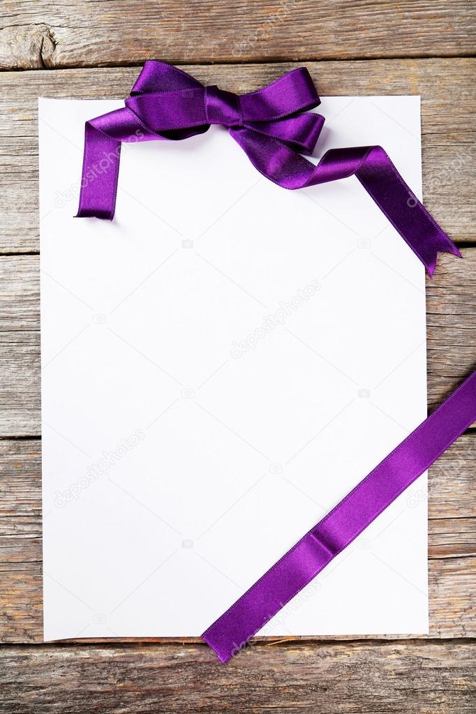 Blank paper sheet with purple bow