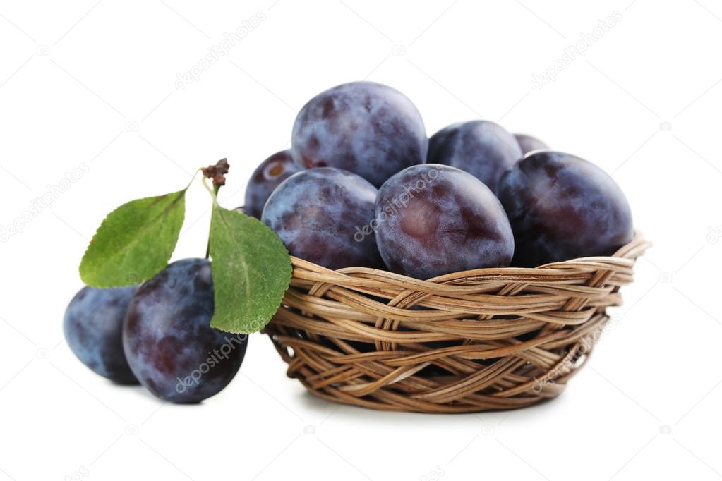 Fresh plums in basket