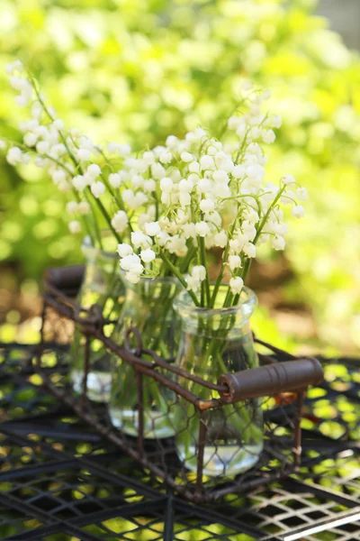 Lily of the Valley in bottles — Stock Photo, Image