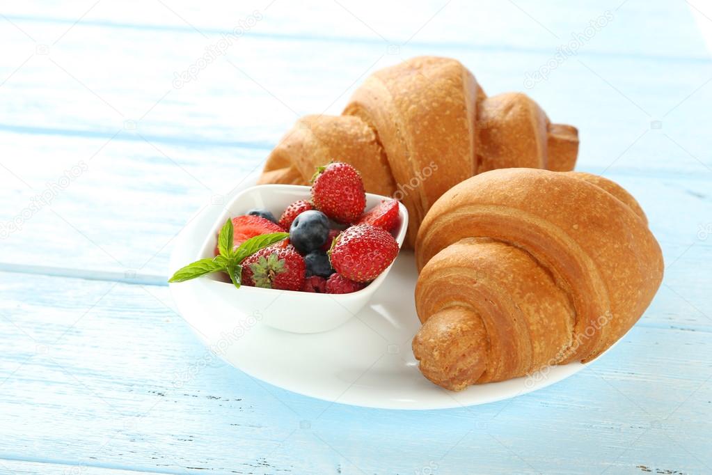 Fresh tasty croissants with berries