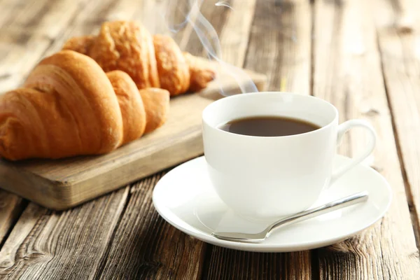 Tasty croissants with cup of coffee — Stock Photo, Image