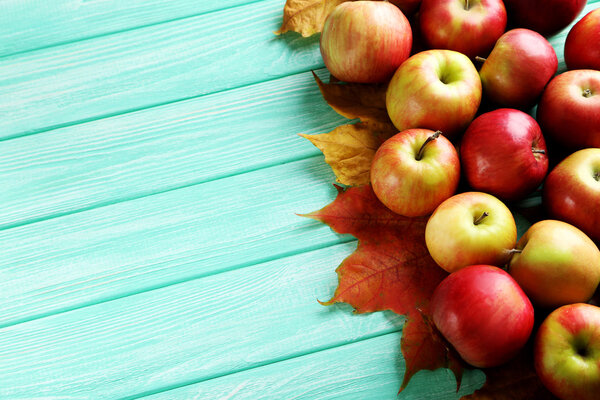 Ripe apples with autumn leaves