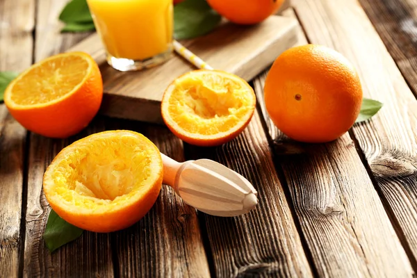 Wooden juicer and oranges — Stock Photo, Image