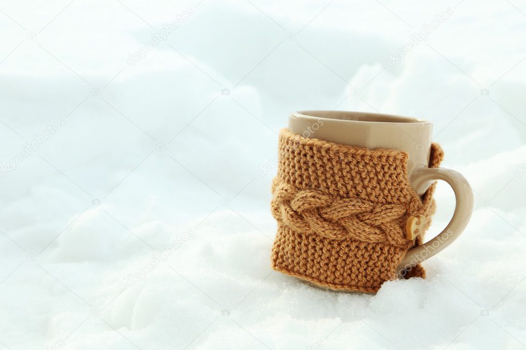 Beige cup on the white snow