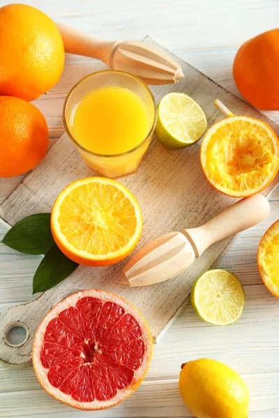 Citrus fruits with juicer — Stock Photo, Image