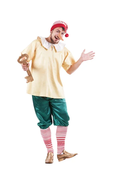 Young smiling man posing in Pinocchio costume or russian buratino — стокове фото