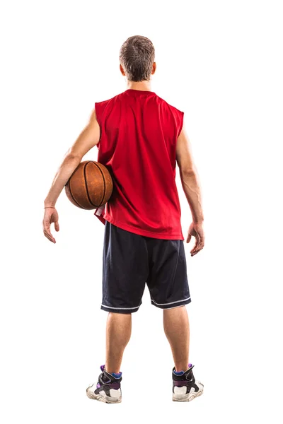 Jogador de basquete de pé com bola das costas isolado em branco — Fotografia de Stock