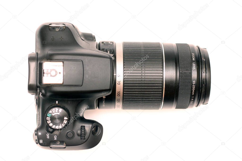 No logos digital SLR camera with large telephoto lens. Top view, studio shooting
