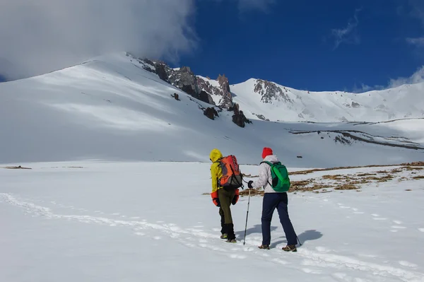 Des alpinistes mâles et femelles montent sur un volcan enneigé . — Photo