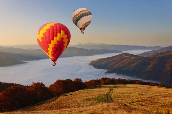 Two Hot Air Balloons Fly Mystical Foggy Carpathian Mountains Stock Picture