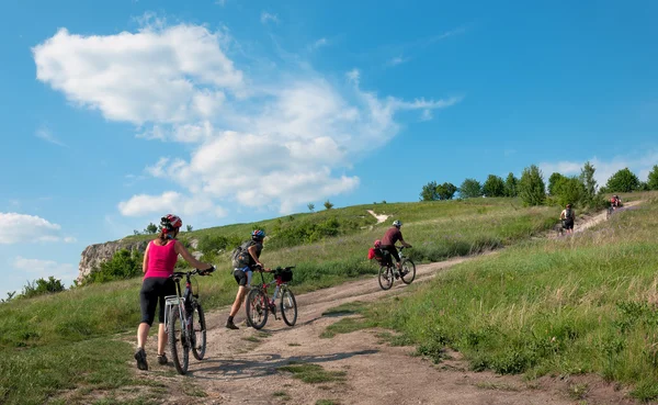 Grupo de turistas paseo en bicicleta de montaña en el camino de tierra . — Foto de Stock