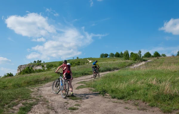 Famille avec jeunes enfants balade en VTT sur route de terre . — Photo