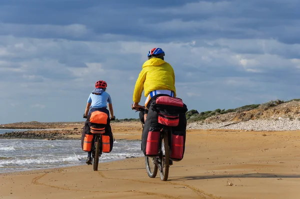 Homme et femme à cheval plage de sable VTT avec sac à dos . — Photo