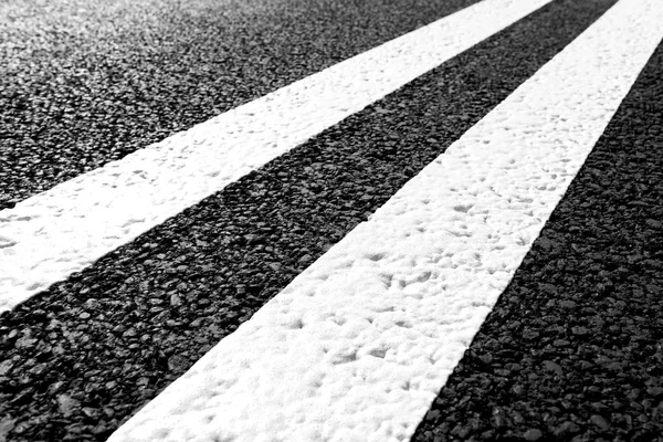 Asphalt road with marking lines white stripes