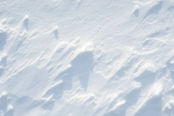 Fresh clean white snow background texture. Winter background with snowflakes and snow mounds. Snow lumps. Seasonal landscape details.