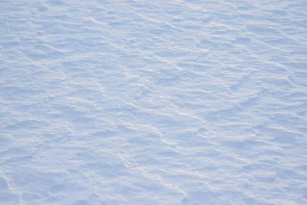 Fresh clean white snow background texture. Winter background with snowflakes and snow mounds. Snow lumps. Seasonal landscape details.