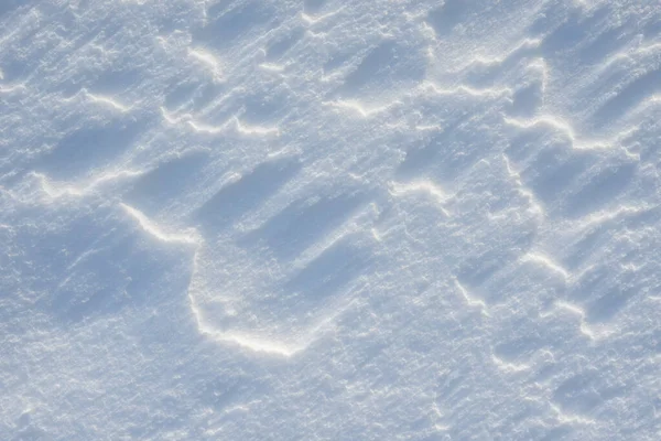 Fresh clean white snow background texture. Winter background with snowflakes and snow mounds. Snow lumps. Seasonal landscape details.