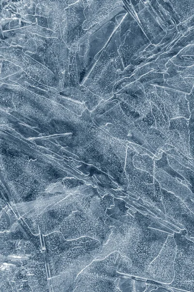 Ice background texture. Frozen water in various geometric abstract shapes. Seasonal natural effect. Cold weather. The surface of the winter water reservoir.