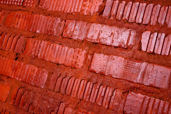 Muro de ladrillo pintado con textura de fondo de pintura roja — Foto de Stock