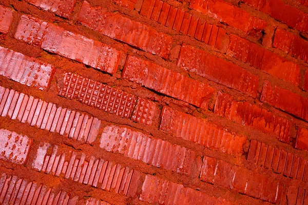 Muro de ladrillo pintado con textura de fondo de pintura roja — Foto de Stock