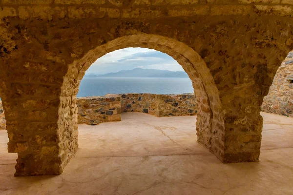 Yellow stone\'s arch and view of the sea from upper town  the medieval  castle of Monemvasia, Lakonia, Peloponnese.