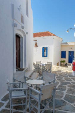 Dar bir sokak beyazlatılmış evleri ve Chora Kythnos, Cyclades, Yunanistan 'da bir kilisesi olan geleneksel Cycladitic sokağı.