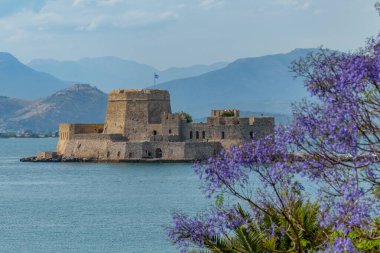 Spring view of historical  Venetian water castle of Bourtzi located in  the old harbour of Nafplio Argolis Greece. clipart