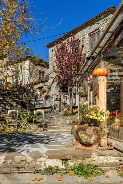 Traditional architecture in a stone street during fall season in the picturesque village of papigo in Epirus zagori greece